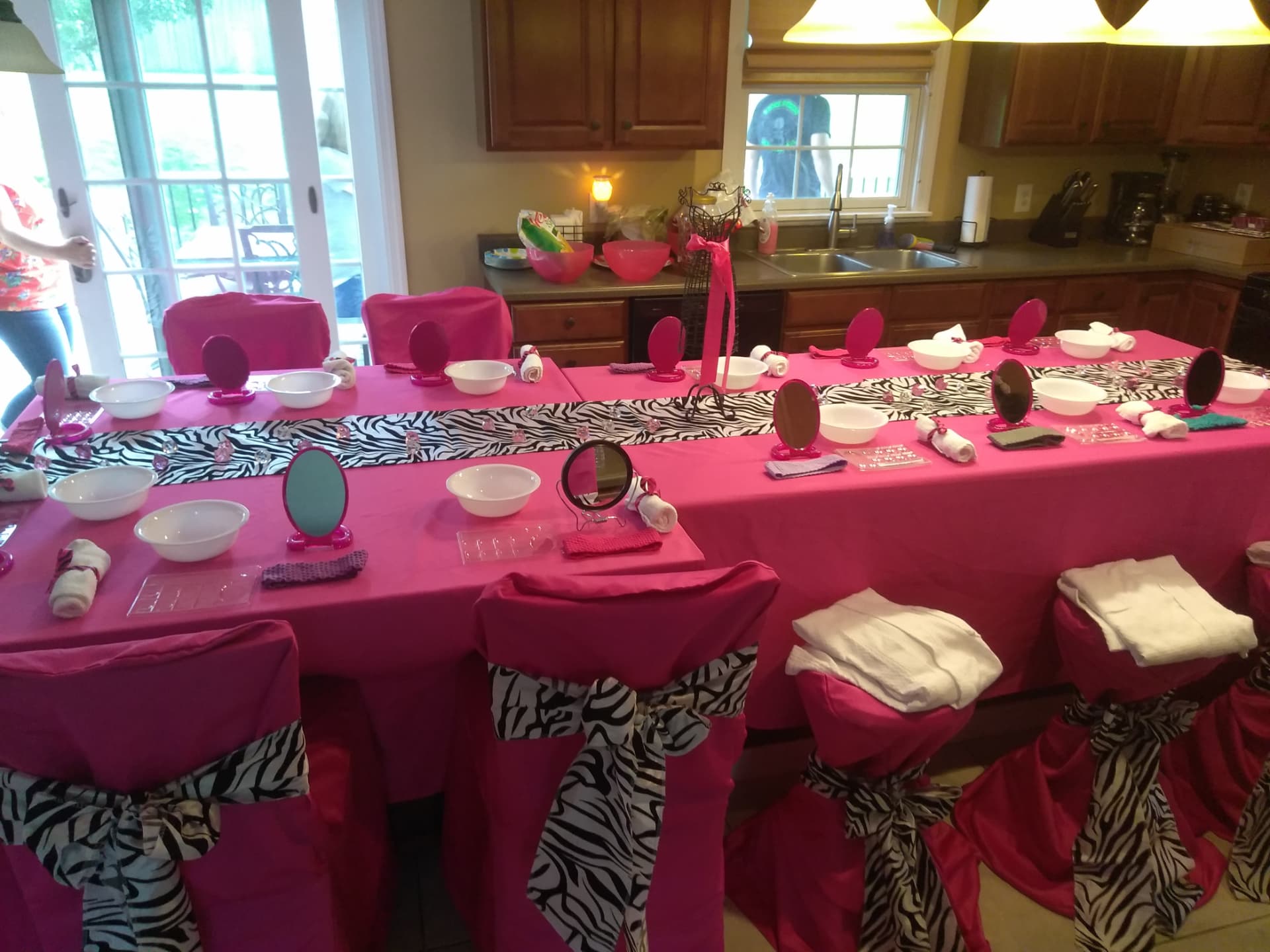 Spa party table set with mirrors, bowls, and rolled towels
